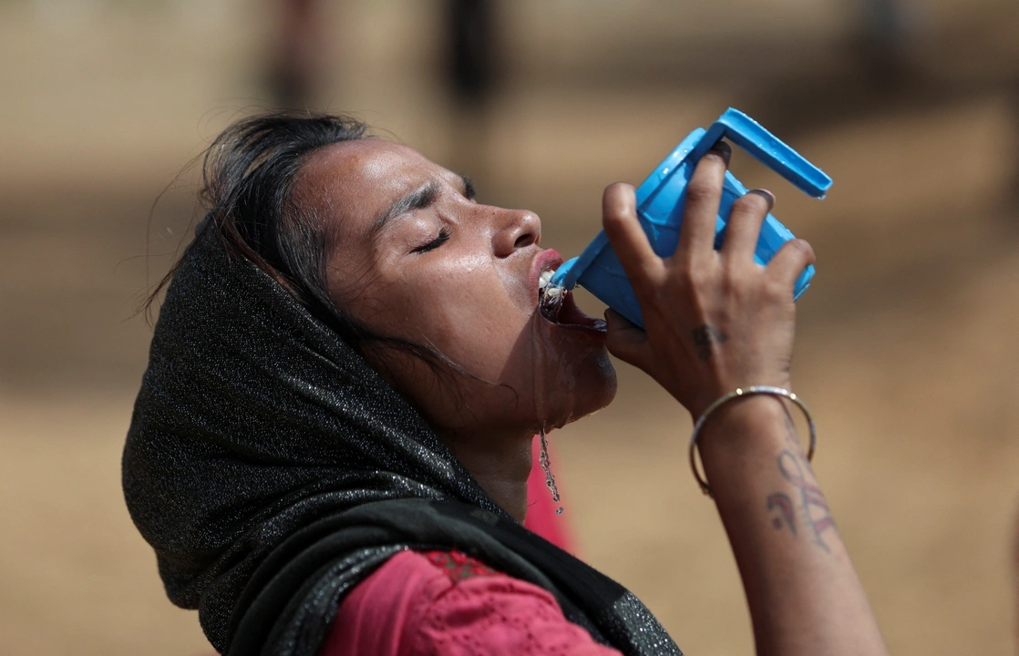 A woman drinks water from a mug on a hot summer day in New Delhi, India June 9, 2023. REUTERS/Anushree Fadnavis/ File photo