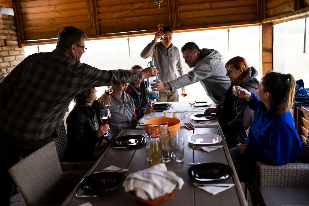 Members of an eco-community have lunch at member Istvan David's home in Nagybereny, Hungary, March 26, 2024.  REUTERS/Marton Monus