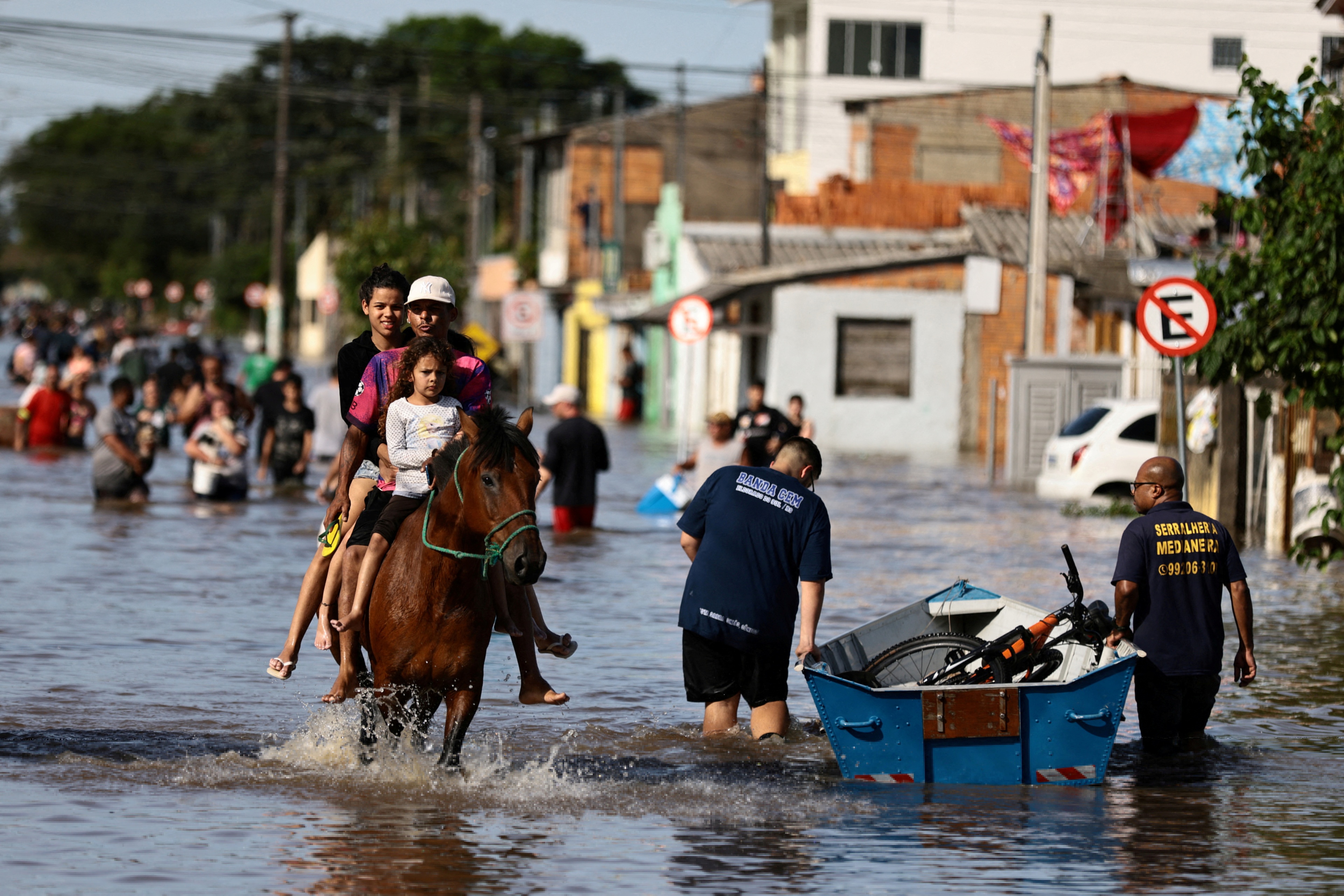 FILE PHOTO: People ride on a horse due to flooding caused by heavy rains in Eldorado do Sul, Rio Grande do Sul state, Brazil November 20, 2023. REUTERS/Diego Vara/File Photo