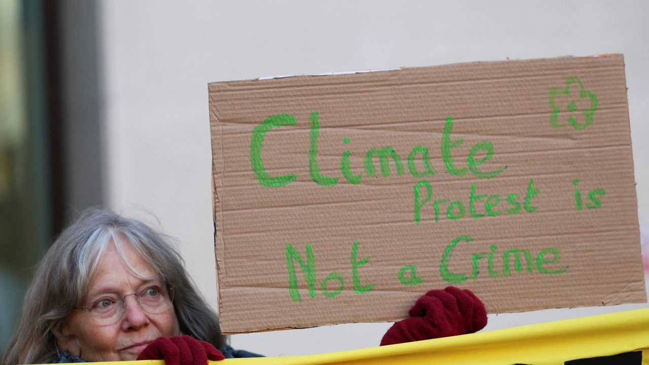 A climate change protester holds a sign outside Westminster Magistrates' Court, on the day of Greta Thunberg's trial in London, Britain, February 1, 2024. REUTERS/Isabel Infantes