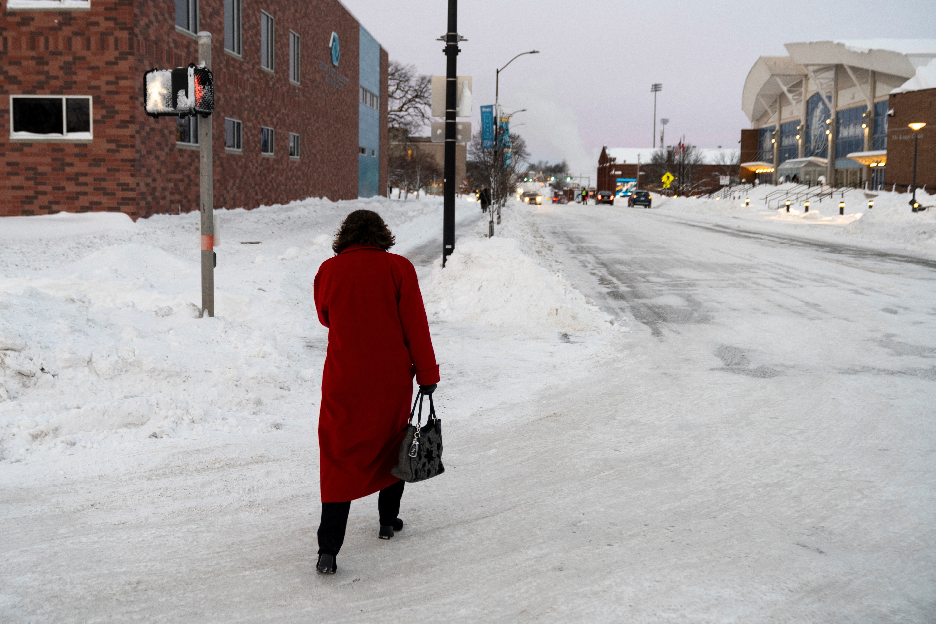A woman walks down a street amid sub-zero temperatures, ahead of the Iowa state caucus vote, in Des Moines, Iowa, U.S., January 15, 2024. REUTERS/Cheney Orr