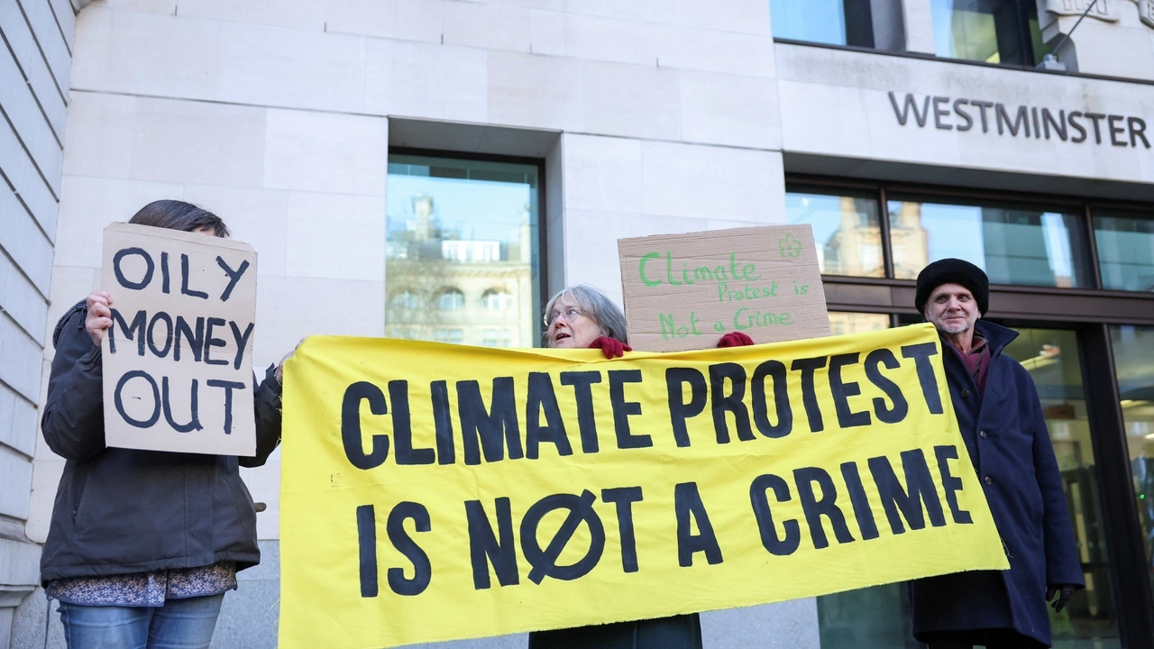Climate change protesters hold signs outside Westminster Magistrates' Court, on the day of Greta Thunberg's trial in London, Britain, February 1, 2024. REUTERS/Isabel Infantes
