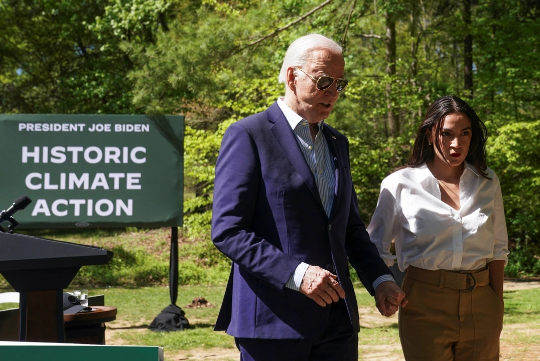 U.S. President Joe Biden and U.S. Representative Alexandria Ocasio-Cortez (D-NY) walk together at an event to commemorate Earth Day during a visit to Prince William Forest Park in Triangle, Virginia, U.S., April 22, 2024.  REUTERS/Kevin Lamarque