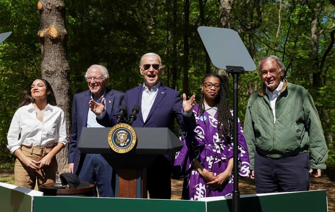 U.S. President Joe Biden gestures as U.S. Senator Bernie Sanders (I-VT), U.S. Representative Alexandria Ocasio-Cortez (D-NY), U.S. Senator Ed Markey (D-MA) and Za'Nyia Kelly stand with him, at an event to commemorate Earth Day during a visit to Prince William Forest Park in Triangle, Virginia, U.S., April 22, 2024.  REUTERS/Kevin Lamarque
